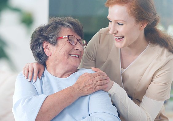 caregiver and elder woman looking at each other