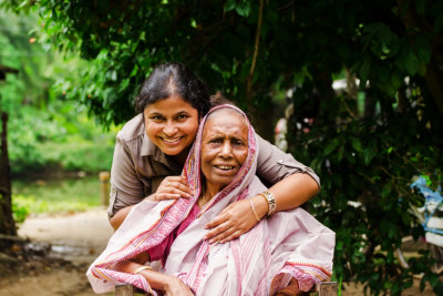 caregiver and woman in wheelchair smiling